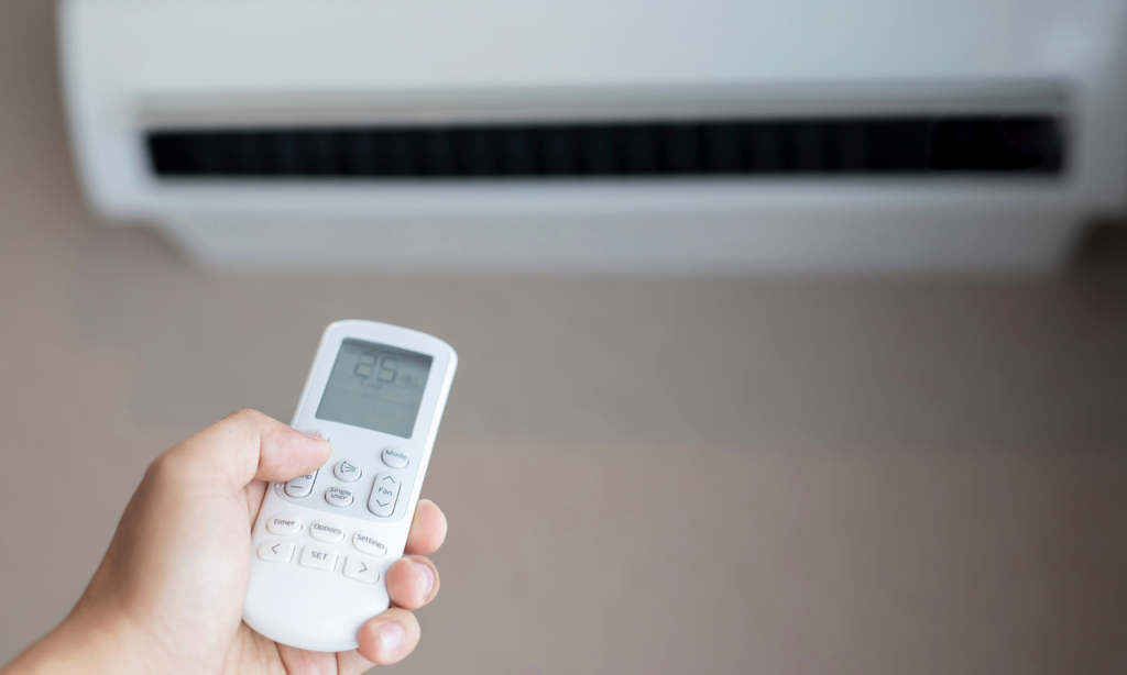 A person increasing the AC temperature.